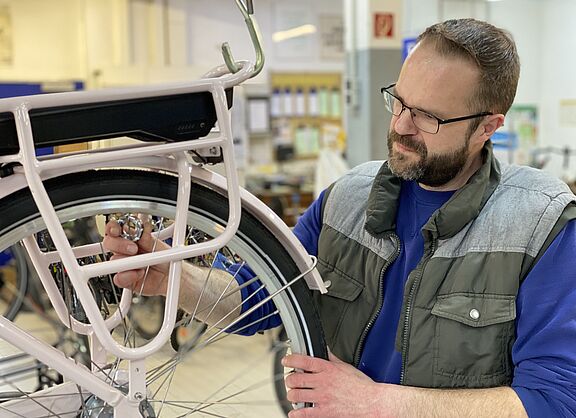 Fahrradmonteur prüft Fahrrad 